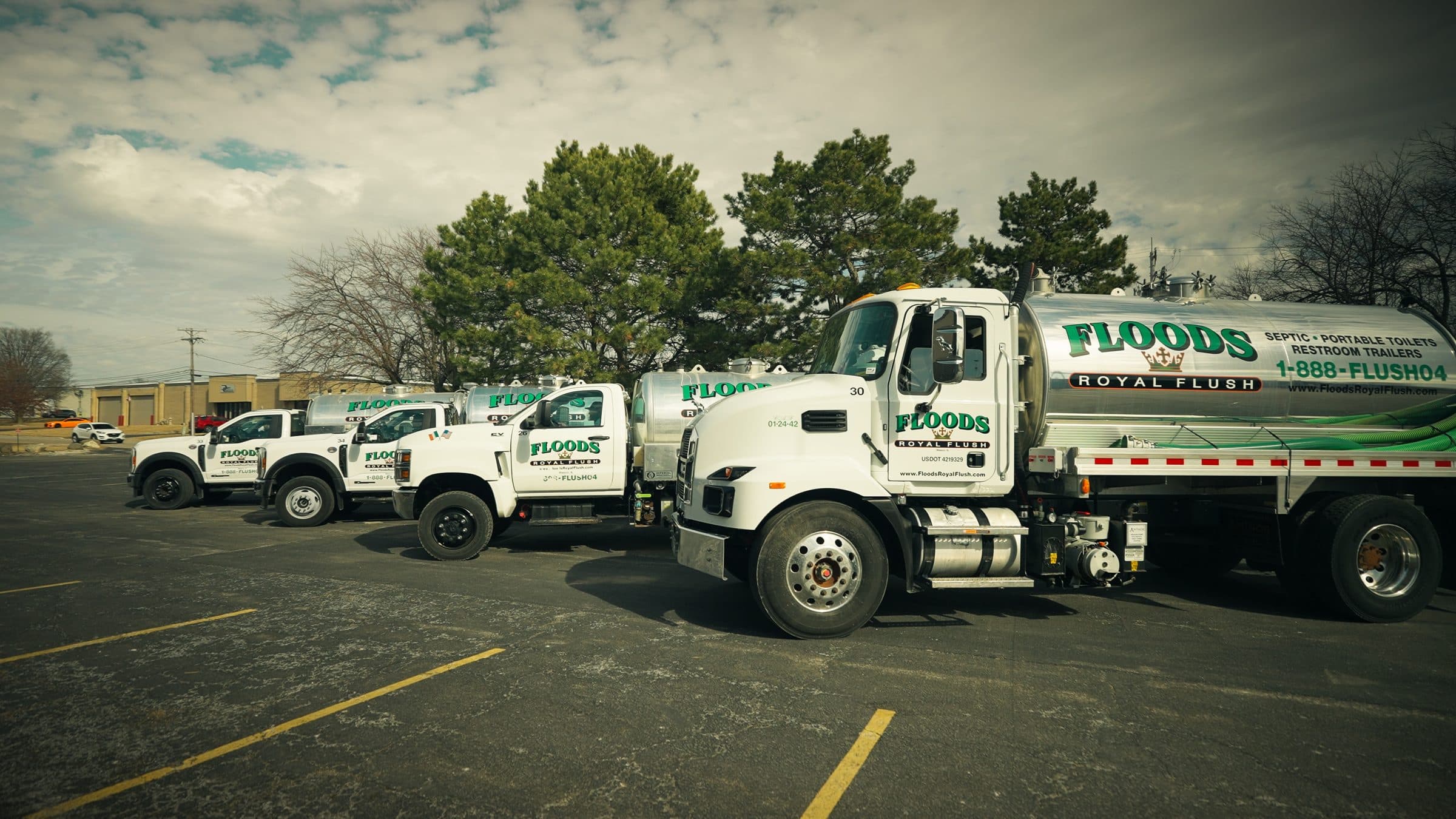 The Floods Royal Flush fleet of vacuum trucks and service pickups lined up in the yard