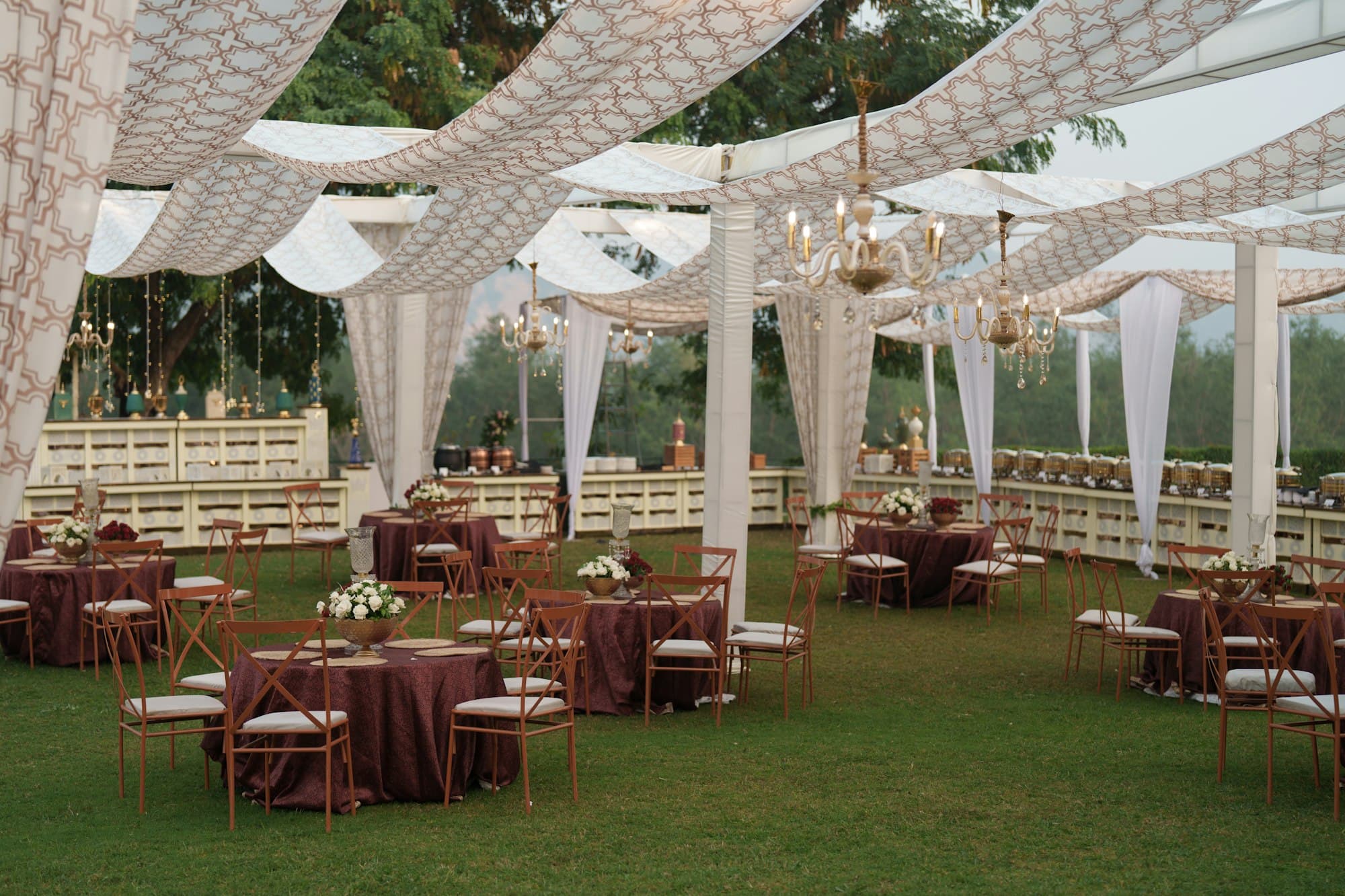 Elegant tented wedding reception with round tables