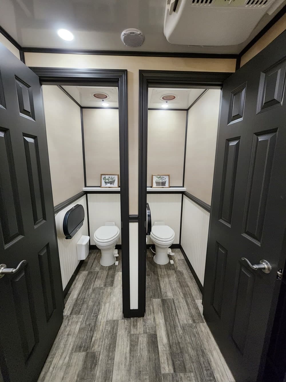 Interior of a Floods Royal Flush restroom trailer with two private flushing stalls
